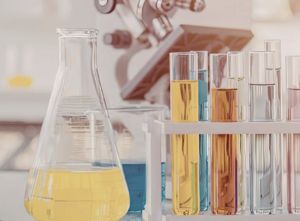 Laboratory glassware with colorful liquids and microscope